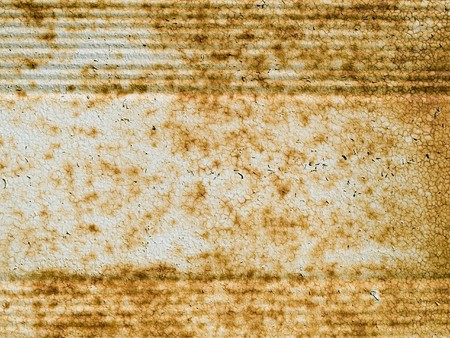 Rusting metal with cracked, peeling paint.