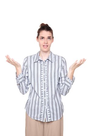 Isolated studio shot of a Caucasian woman looking up with a disbelieving expression and arms raised.の写真素材