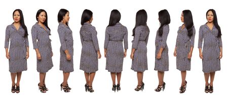 Isolated full length studio shot of the view of a Latina woman in a dress as she rotates by 45 degree angles. の写真素材