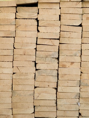 Stock texture or background photo of a pile of wood beams used for framing.