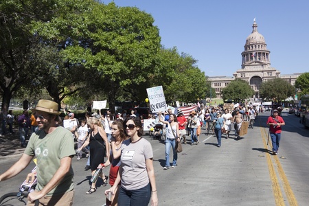 AUSTIN, TX - OCTOBER 15: An unidentified group of protestors carry signs down Congress Avenue during the 'Occupy Austin' march to the Texas State Capitol on October 15th, 2011 in Austin.のeditorial素材