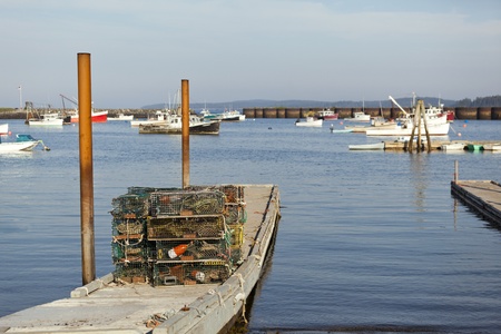 Lobster pots stacked on a dock, ready to be loaded into a lobster boat.の写真素材