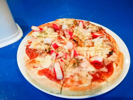 Seafood pizza on white dish.の写真素材