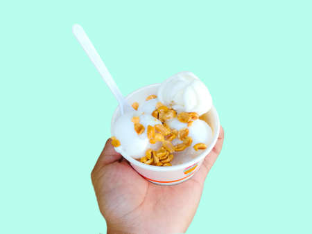 Ice cream on hand with blue pastel background.の写真素材