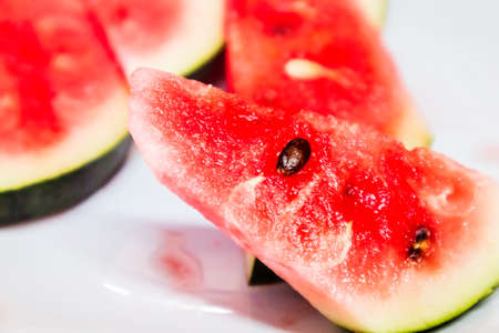 Close-up fresh sliced watermelon on white plate