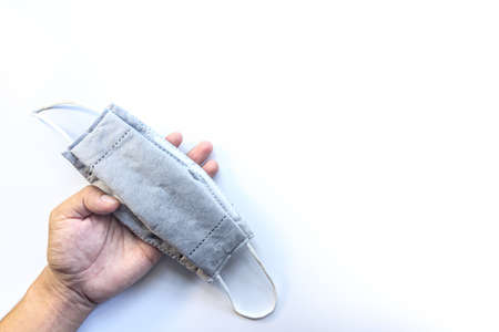 Surgical mask on man hand use for protection against pollution and virus. Concept: Please wear a mask to protect yourself from viruses.の写真素材