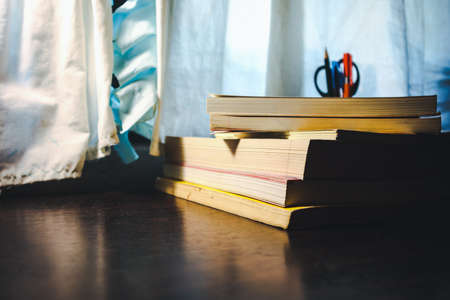 Stack of old book on table.Concept : work and learn from home.の写真素材