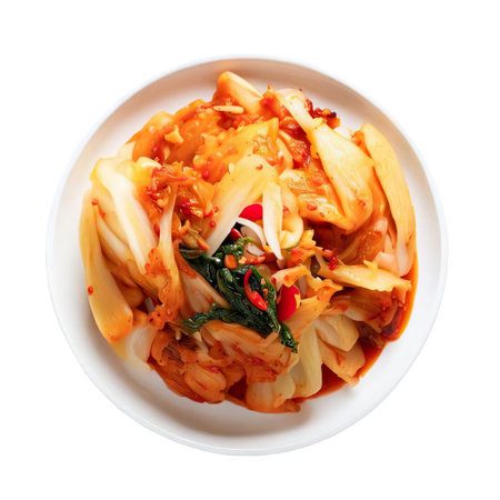 Kimchi on white plate is traditional Korean food usually made with Chinese cabbage. Placed on isolated white or transparent background. Top view concept of food and eating culture of people in Asia.の素材