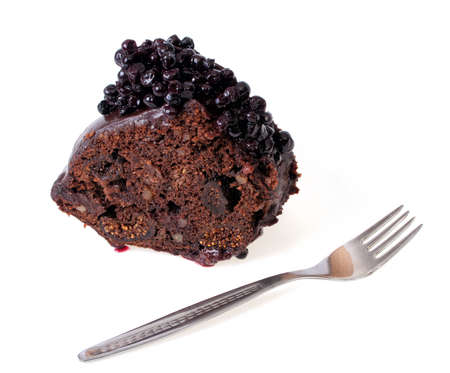 Piece of cocoa cake with chocolate glaze and blueberriesの写真素材