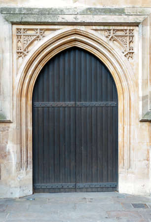 Wooden door with arch and metal elementsの写真素材