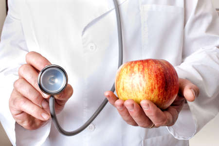Doctor offer apple or stethoscopeの写真素材