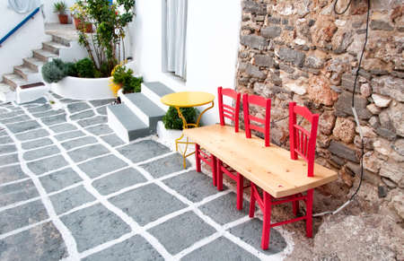 Wooden bench on narrow street in Naussa, Paros island, Greeceの写真素材