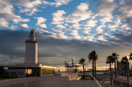 Lighthouse in Malaga in Andalusia, Spain at sunsetの写真素材