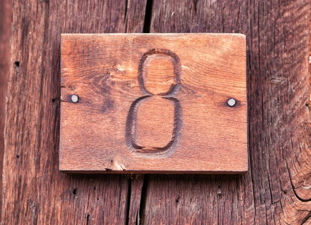 Carved number eight on wooden background, Number 8