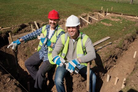 Two male construction workers having a lunch break togetherの写真素材