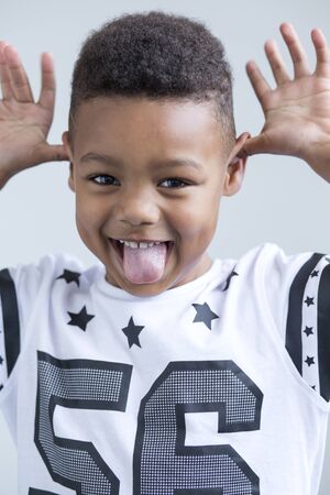 young boy pulling a face at the cameraの写真素材