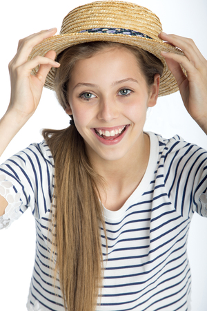 Beautiful girl posing with a straw hat against a white background.の写真素材