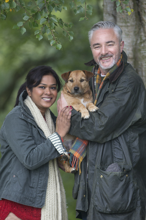 Portrait of a couple with their dog whilst out on a walk.の写真素材