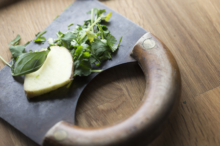 Ginger and parsley presented on a herb cutterの写真素材