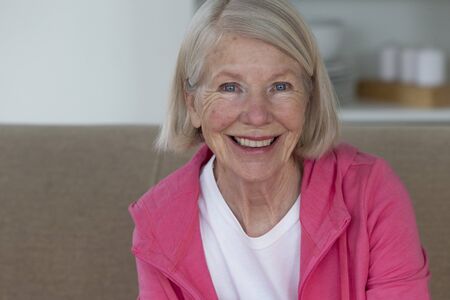 Portrait of a senior woman. She is smiling and looking at the camera.の写真素材