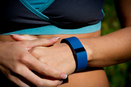Young woman using a fitness watch during her run.の写真素材