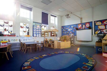 Landscape image of an empty, nursery classroom. there is a rug in the middle of the room.の写真素材