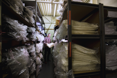 Senior businessman is getting stock from the warehouse.の写真素材