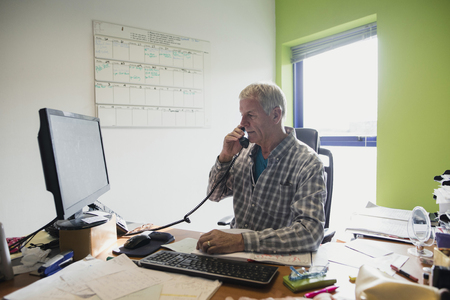 Businessman working in an office at home.の写真素材