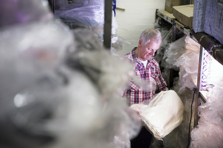 Senior businessman is getting stock from the warehouse.の写真素材
