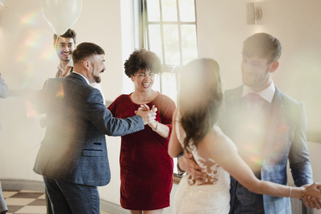 First partner dance at a wedding. All of the couples are dancing together along with the bride and groom.の写真素材