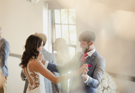 Bride and groom are enjoying dancing together on their wedding day. の写真素材