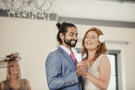 Bride and groom are sharing their first dance on their wedding day. の写真素材