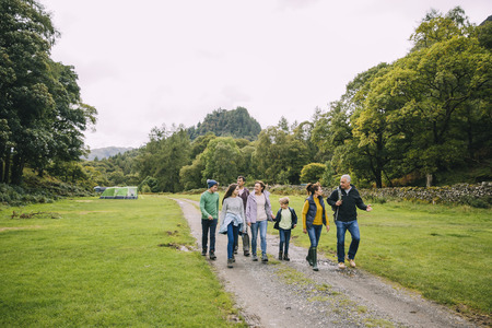 Three generation family are leaving the campsite they are staying in to go for a hike. の写真素材
