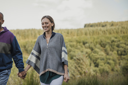 Happy Couple taking a walk together in the country side.の写真素材