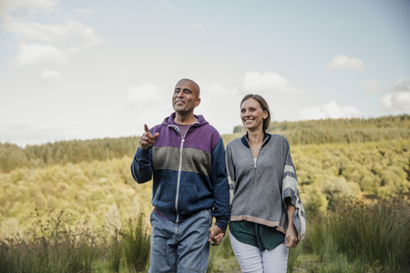 Husband and Wife out for a walk in the country side, having a discussion.の写真素材