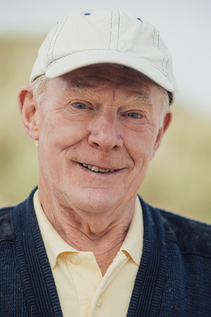 Portrait of elderly man in casual clothing at the beach.の写真素材