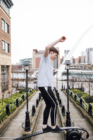 Freerunner is balancing on railings of a brdige. の写真素材