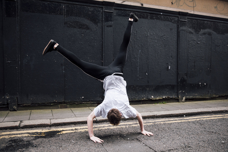 Freerunner is doing a cartwheel in the street. の写真素材