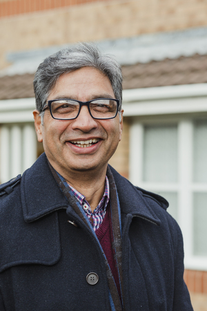 Portrait of a mature man with glasses outdoors.の写真素材