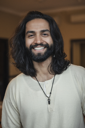 Close-up, front view headshot of a young male adult smiling at the camera.の写真素材