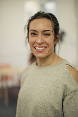 Portrait of a mid-adult smiling woman looking at the camera.の写真素材