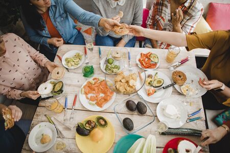 High angle view of a small group of female friends preparing a healthy lunch inside of a...