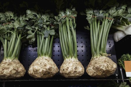A close-up shot of an abundance of fresh celery on display at a market stall.