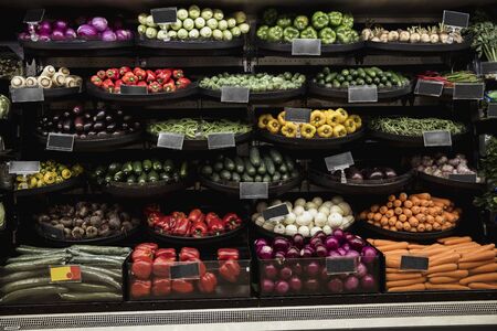 A wide-view shot of an abundance of fresh vegetables on display at a market stall.の写真素材