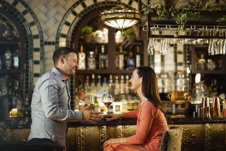 A couple having a drink together at a bar.の写真素材