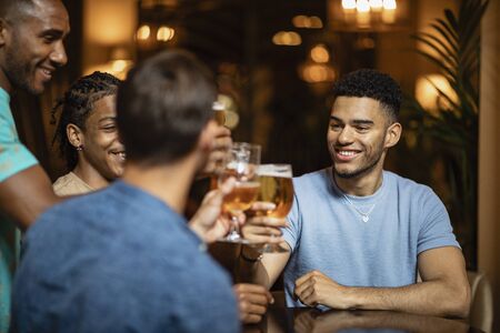 A group of male friends having a pint of beer together in a bar.の写真素材
