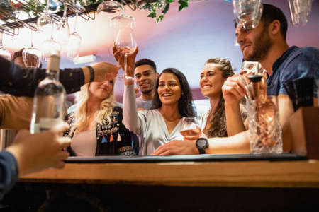 A group of friends havng drinks together in a bar.の写真素材