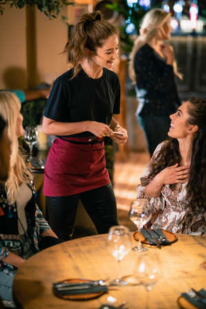 A waitress taking a customer's order at a restaurant in Newcastle-Upon-Tyne.の写真素材