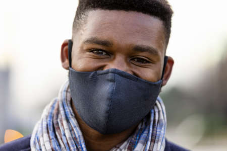 Headshot of man with face covering looking towards cameraの写真素材