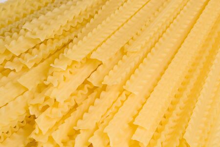 Abstact background from raw italian pasta. Close-up.